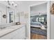 Bright bathroom with double vanity, and an open view to the main bedroom with a waterfront view at 308 Timber Lake Dr, Bradenton, FL 34210
