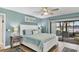A cozy bedroom with a lake view and access to a screened-in lanai at 308 Timber Lake Dr, Bradenton, FL 34210