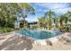 Inviting community pool area with lounge chairs, lush landscaping, and ample space for relaxation at 308 Timber Lake Dr, Bradenton, FL 34210