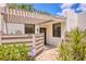 Inviting condo entrance with a pergola, privacy fence, and lush landscaping at 308 Timber Lake Dr, Bradenton, FL 34210
