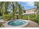 Inviting hot tub area with lush landscaping, and ample space for relaxation by the pool at 308 Timber Lake Dr, Bradenton, FL 34210