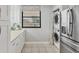 Cozy kitchen featuring white cabinets, stacked washer/dryer, and tiled floors at 308 Timber Lake Dr, Bradenton, FL 34210