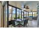 Sunroom with dining area and comfortable seating, offering beautiful views of the lake for relaxed dining at 308 Timber Lake Dr, Bradenton, FL 34210