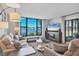 Bright and airy living room with panoramic view of lake with beach scene on TV at 308 Timber Lake Dr, Bradenton, FL 34210