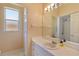 Bright bathroom with a large mirror, vanity with sink, and enclosed shower area at 3108 River Woods Dr, Parrish, FL 34219