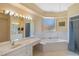 Spacious bathroom boasts a large soaking tub, vanity, and shower at 3108 River Woods Dr, Parrish, FL 34219