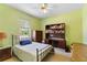 Comfortable bedroom featuring built in desk, shelving, and ceiling fan at 3108 River Woods Dr, Parrish, FL 34219