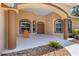 Inviting front entrance with warm colors, arched windows, and a charming porch with decorative stones and attractive chair at 3108 River Woods Dr, Parrish, FL 34219