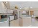 Bright kitchen featuring white cabinets, a stainless steel refrigerator, and ample counter space at 3108 River Woods Dr, Parrish, FL 34219