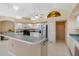 Bright kitchen featuring white cabinets, a stainless steel refrigerator, and ample counter space at 3108 River Woods Dr, Parrish, FL 34219
