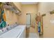 Functional laundry room with washer, dryer, and folding ironing board at 3108 River Woods Dr, Parrish, FL 34219