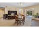 Cozy living room with neutral carpet, ceiling fan, and sliding glass doors to the patio at 3108 River Woods Dr, Parrish, FL 34219