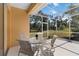 Enclosed patio with seating and views of the surrounding nature at 3108 River Woods Dr, Parrish, FL 34219