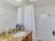 Well-maintained bathroom featuring a granite vanity, a tub with shower, and a large mirror reflecting the clean, white interior at 3248 Mangrove Point Dr, Ruskin, FL 33570