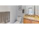 Cozy half bathroom with granite counter tops, wooden cabinets and towel racks and laundry room in the mirror at 3248 Mangrove Point Dr, Ruskin, FL 33570
