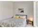 Cozy bedroom featuring a queen size bed with decorative pillows, a bedside table, and natural light from the window at 3248 Mangrove Point Dr, Ruskin, FL 33570