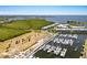 A picturesque marina features rows of boats docked in the water, surrounded by green land and residential buildings at 3248 Mangrove Point Dr, Ruskin, FL 33570