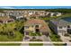 Inviting two-story home with a paver driveway, a tile roof, and mature landscaping in a Gathering neighborhood at 3375 Juniper Springs St, Wesley Chapel, FL 33543