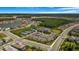 Aerial view of the community featuring tennis courts, pool, clubhouse, and playgrounds amid homes, streets, and green spaces at 3375 Juniper Springs St, Wesley Chapel, FL 33543
