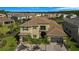 Beautiful two-story home with tile roof and balcony, surrounded by lush landscaping in a residential community at 3375 Juniper Springs St, Wesley Chapel, FL 33543