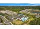 Aerial view of community amenities with a pool, clubhouse, tennis courts, and parking, surrounded by lush landscaping and homes at 3375 Juniper Springs St, Wesley Chapel, FL 33543