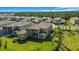 View of lush green backyard, featuring a covered patio and palm trees on a sunny day at 3375 Juniper Springs St, Wesley Chapel, FL 33543