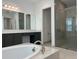 Modern bathroom featuring a separate shower and bathtub, and dual sinks, providing a spa-like retreat at 3375 Juniper Springs St, Wesley Chapel, FL 33543