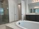 Bright primary bathroom with walk-in shower, soaking tub and double vanity at 3375 Juniper Springs St, Wesley Chapel, FL 33543