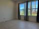 Neutral bedroom features a large window with natural light and views of the community at 3375 Juniper Springs St, Wesley Chapel, FL 33543