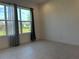Neutral bedroom features a large window with natural light and views of the community at 3375 Juniper Springs St, Wesley Chapel, FL 33543