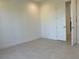 Bedroom with tile flooring and a door leading to the hallway at 3375 Juniper Springs St, Wesley Chapel, FL 33543