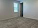 A well-lit bedroom features neutral walls, plush carpeting, and a window with blinds for natural light at 3375 Juniper Springs St, Wesley Chapel, FL 33543