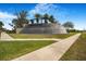 Elegant gated community entrance with manicured landscaping, stone accents, and a waterfall feature at 3375 Juniper Springs St, Wesley Chapel, FL 33543