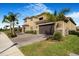 A shot of the exterior of a two-story house with palm trees and manicured landscaping at 3375 Juniper Springs St, Wesley Chapel, FL 33543