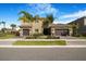 Two-story house with a two-car garage, complemented by palm trees in a manicured front lawn at 3375 Juniper Springs St, Wesley Chapel, FL 33543