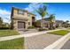 Exterior of a two-story home with a two-car garage, complimented by palm trees in a manicured front lawn at 3375 Juniper Springs St, Wesley Chapel, FL 33543
