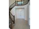 Grand foyer showcasing an elegant curved staircase and double-door entrance at 3375 Juniper Springs St, Wesley Chapel, FL 33543