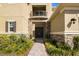 Front entrance to a two-story home with double doors, stone accents, and manicured landscape at 3375 Juniper Springs St, Wesley Chapel, FL 33543