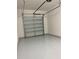 Garage featuring an automatic door and updated flooring at 3375 Juniper Springs St, Wesley Chapel, FL 33543