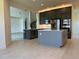 Spacious kitchen with modern gray cabinets, stainless steel appliances, and a large center island with white countertop at 3375 Juniper Springs St, Wesley Chapel, FL 33543