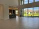 Bright and spacious living room with high ceilings, modern windows, and sleek tile flooring at 3375 Juniper Springs St, Wesley Chapel, FL 33543