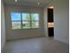 Living room with a large window and view into a connected kitchen at 3375 Juniper Springs St, Wesley Chapel, FL 33543
