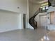 Elegant staircase with dark wood banister leading to the second floor, complementing the home's open design at 3375 Juniper Springs St, Wesley Chapel, FL 33543