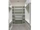 Well-organized walk-in closet featuring custom shelving and drawer systems for optimal storage and organization at 3375 Juniper Springs St, Wesley Chapel, FL 33543