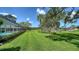 Expansive backyard with lush lawn, mature trees, and view of golf course, creating a serene outdoor retreat at 3572 Ferndell, Sarasota, FL 34235