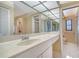 Bright bathroom features a spacious countertop, mirrored wall, and a separate shower room at 3572 Ferndell, Sarasota, FL 34235