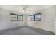 Comfortable bedroom with two windows, a ceiling fan, and neutral-toned carpet at 3572 Ferndell, Sarasota, FL 34235