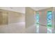 Bright foyer with white tile floors and decorative stained-glass sidelights flanking the front door at 3572 Ferndell, Sarasota, FL 34235