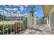 Charming home with decorative wrought iron gate, lush landscaping, and brick pavers at 3572 Ferndell, Sarasota, FL 34235