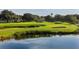 Scenic golf course view with lush green fairways, sand traps, and pond at 3572 Ferndell, Sarasota, FL 34235